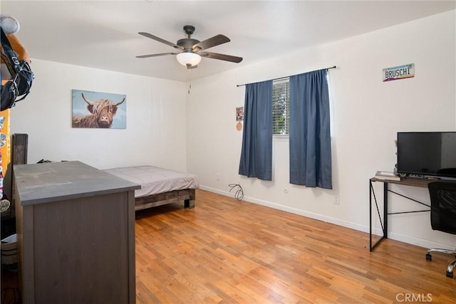 bedroom with ceiling fan and light wood-type flooring