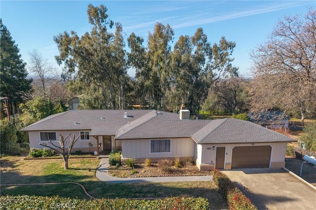 ranch-style home featuring a garage and a front yard