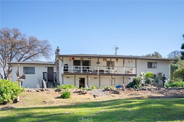 rear view of property featuring a lawn