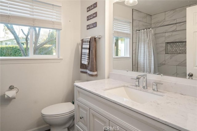 bathroom featuring vanity, toilet, and walk in shower