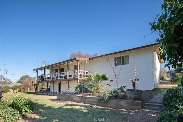 rear view of property with a lawn