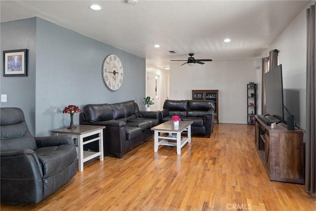 living room with ceiling fan and light hardwood / wood-style floors