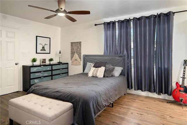 bedroom with hardwood / wood-style floors and ceiling fan