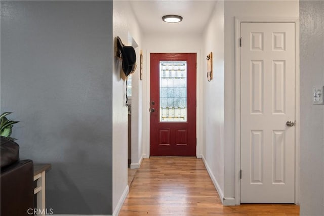 doorway to outside with light wood-type flooring