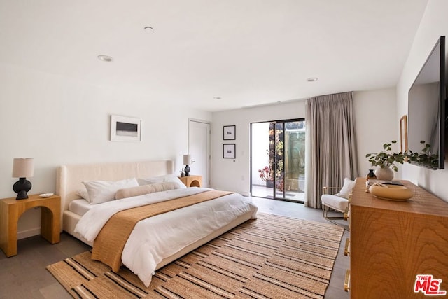 bedroom featuring access to exterior and light wood-type flooring