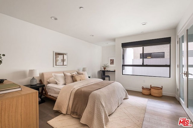 bedroom with hardwood / wood-style flooring