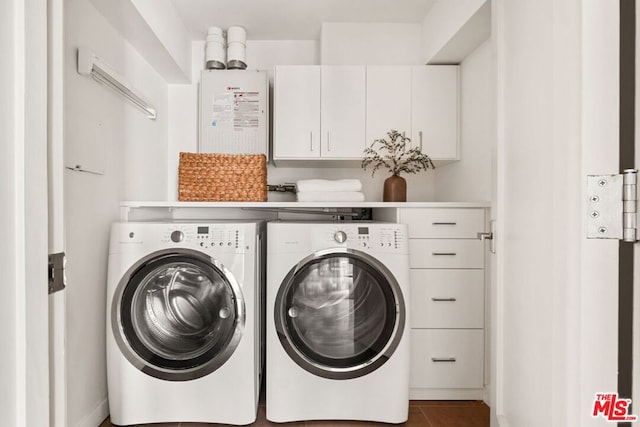 laundry room with cabinets, washer and clothes dryer, tile patterned flooring, and water heater