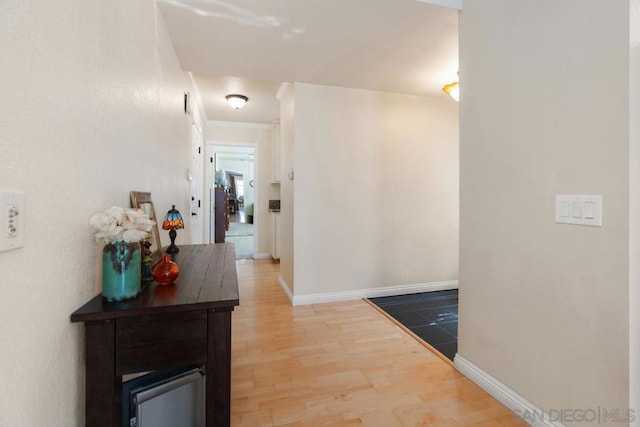 corridor featuring crown molding and hardwood / wood-style floors