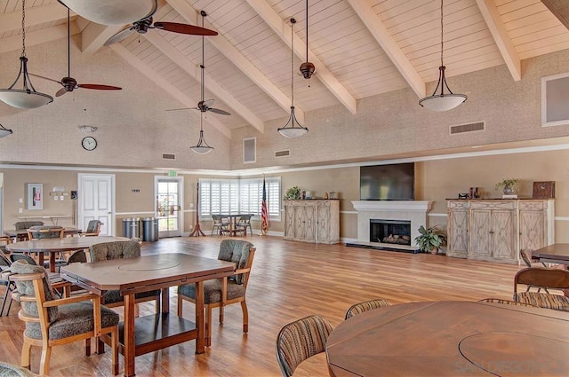 dining space featuring wooden ceiling, beam ceiling, high vaulted ceiling, and light wood-type flooring