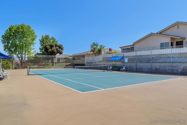 view of tennis court featuring basketball court