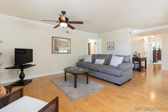 living room featuring crown molding, ceiling fan, and light wood-type flooring