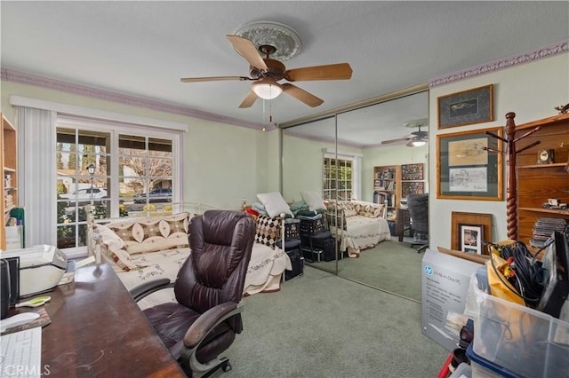 office with ornamental molding, carpet, and ceiling fan