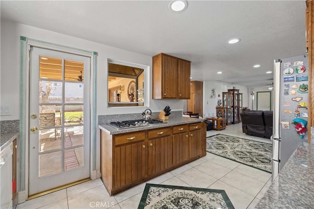 kitchen with ceiling fan, appliances with stainless steel finishes, and light tile patterned floors