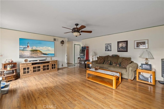 living room featuring hardwood / wood-style floors and ceiling fan