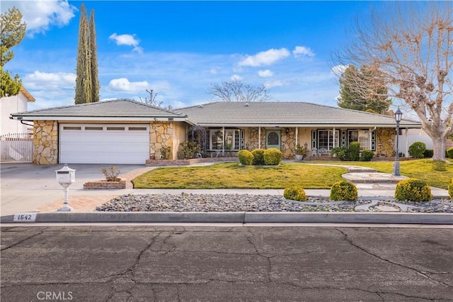 ranch-style house with a garage and a front yard