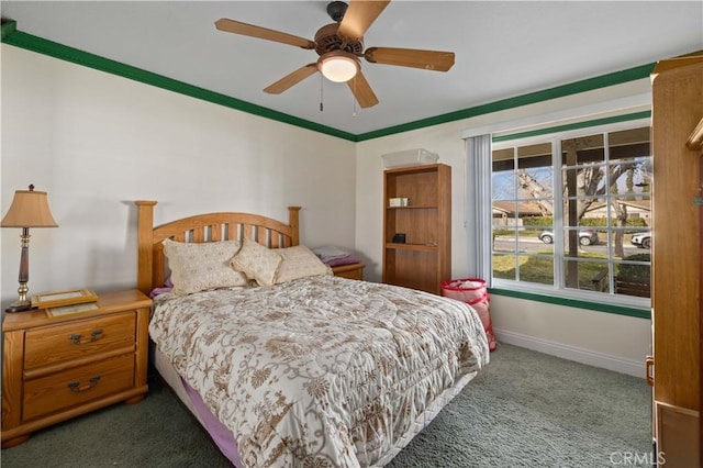 bedroom with crown molding, ceiling fan, and dark carpet