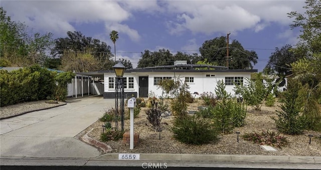 single story home featuring a carport