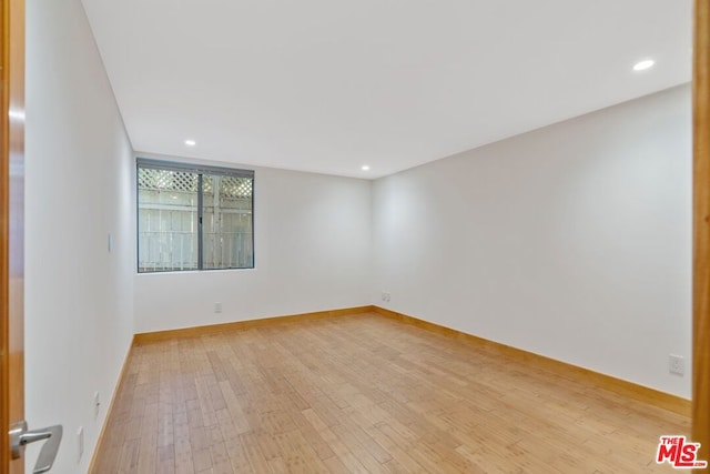 spare room featuring light wood-type flooring