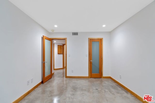 unfurnished room featuring french doors