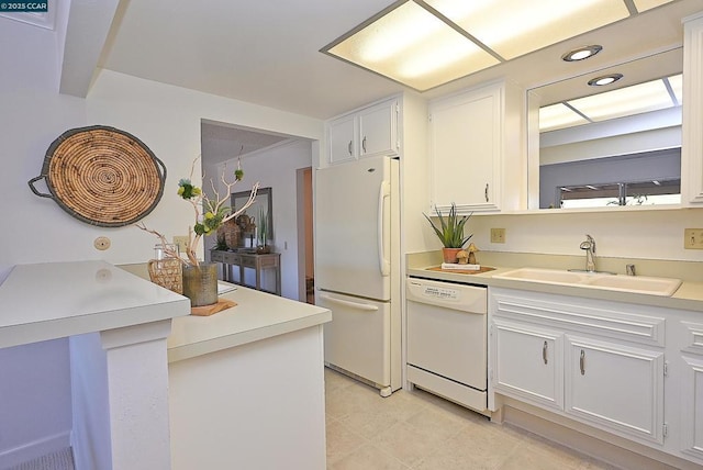 kitchen featuring white cabinetry, sink, and white appliances