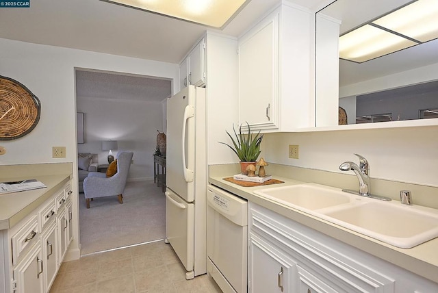 kitchen featuring white cabinetry, white appliances, sink, and light tile patterned floors