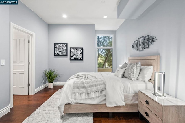 bedroom with dark hardwood / wood-style flooring