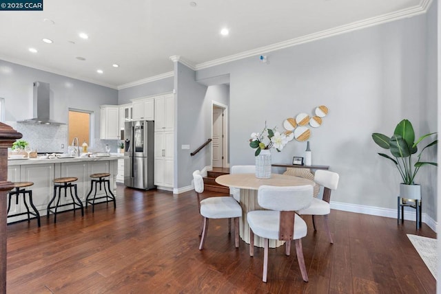 dining space featuring ornamental molding and dark hardwood / wood-style floors