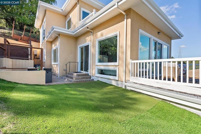 rear view of house featuring a lawn