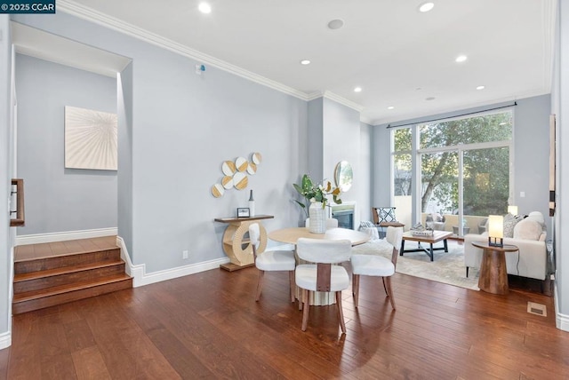 dining room featuring dark hardwood / wood-style flooring, crown molding, and floor to ceiling windows