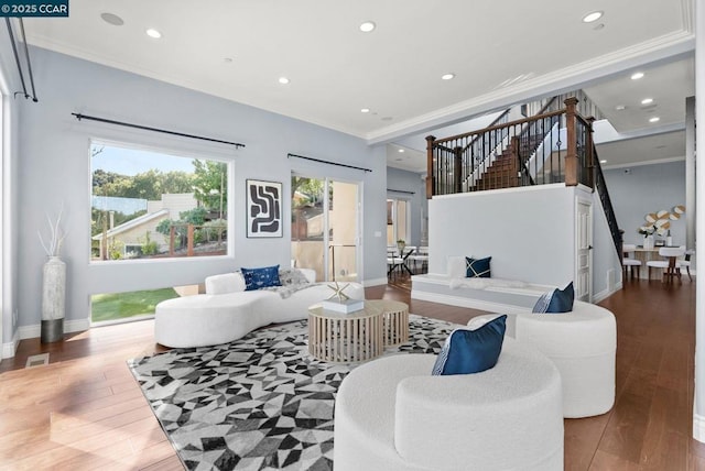 living room with ornamental molding and wood-type flooring