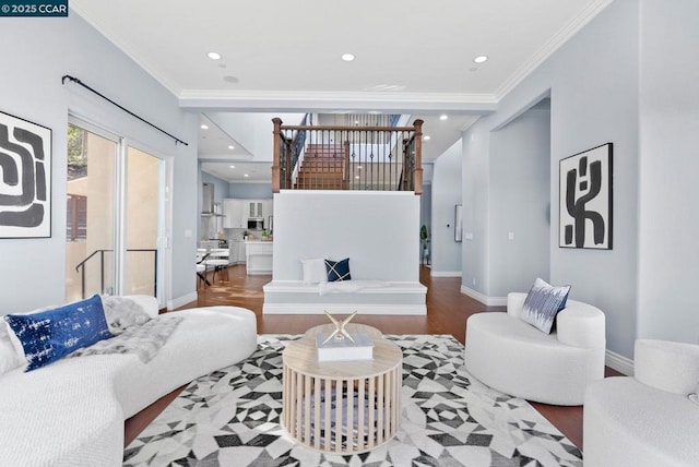 living room with hardwood / wood-style floors and crown molding