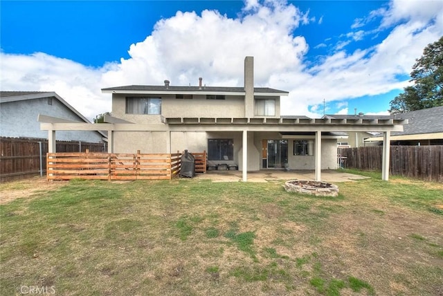 rear view of property with a yard and a patio area