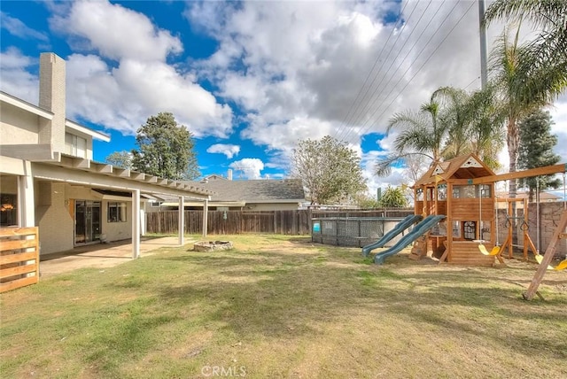 view of yard with a playground and a patio