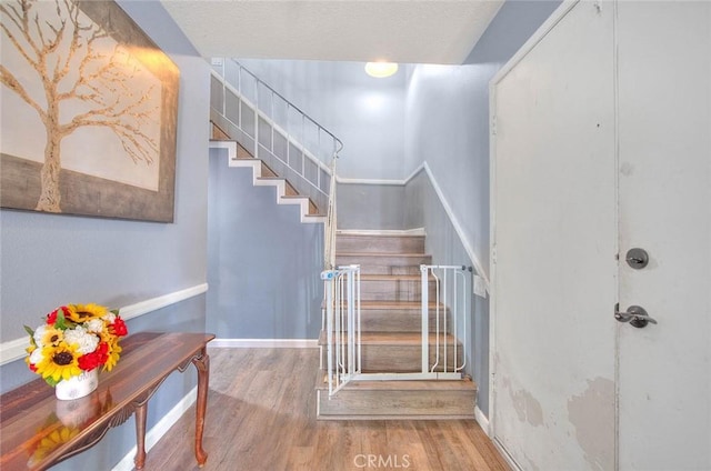 stairway with hardwood / wood-style flooring