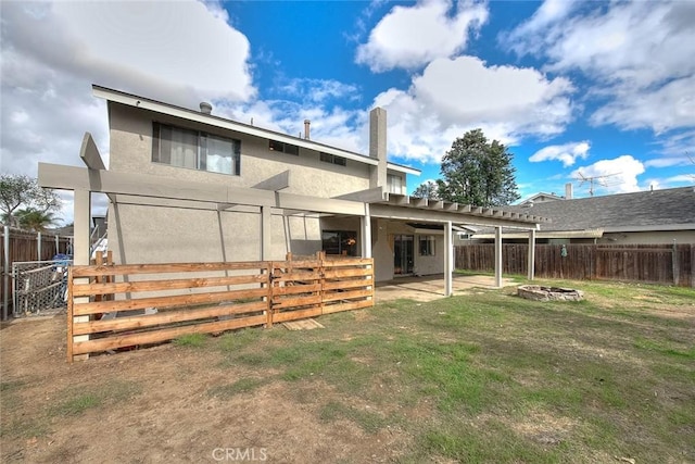 back of house featuring a fire pit