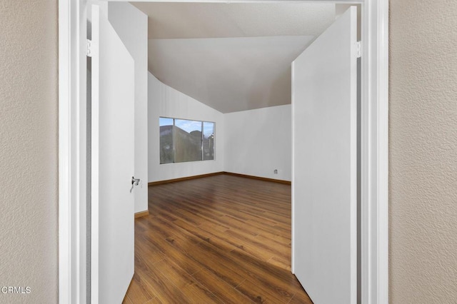 bonus room featuring wood-type flooring and lofted ceiling