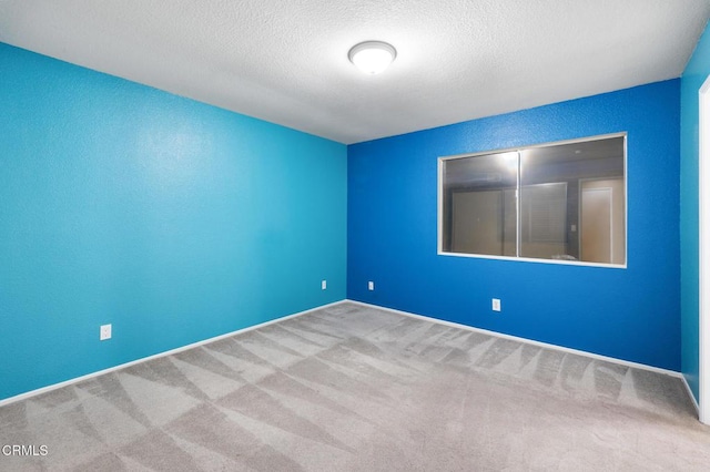 spare room with carpet floors and a textured ceiling