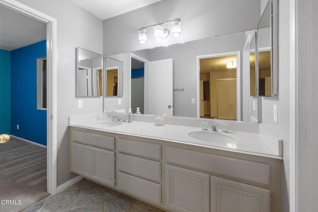 bathroom featuring tile patterned flooring and vanity