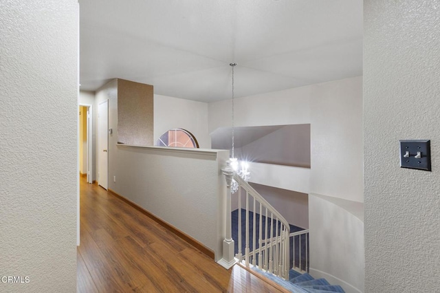 hallway with hardwood / wood-style flooring