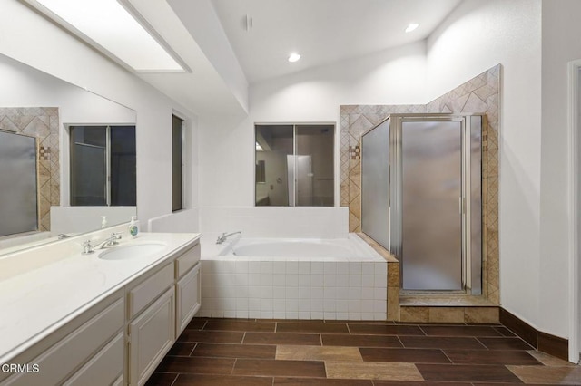 bathroom featuring lofted ceiling, vanity, and shower with separate bathtub