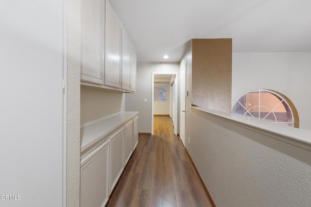 hallway with dark wood-type flooring