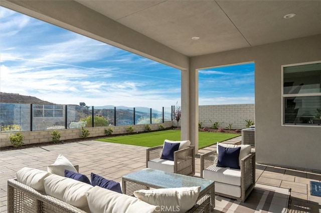 view of patio / terrace featuring an outdoor hangout area and a mountain view