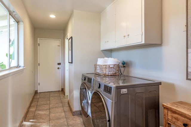 laundry room with cabinets, separate washer and dryer, and light tile patterned floors