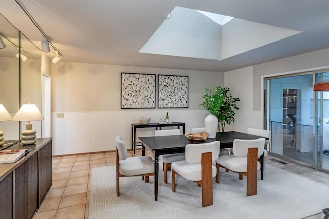 tiled dining space with a skylight