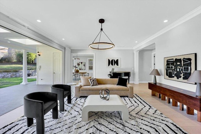 living room with ornate columns, crown molding, and light wood-type flooring