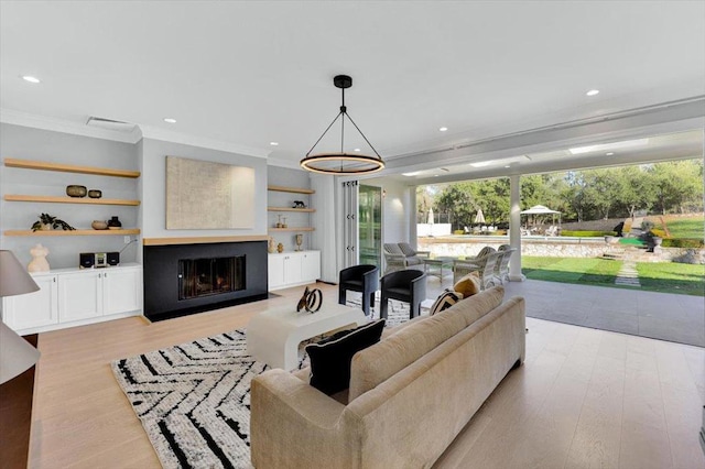 living room with ornamental molding and light wood-type flooring