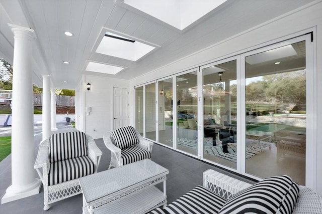 sunroom with a skylight and ornate columns