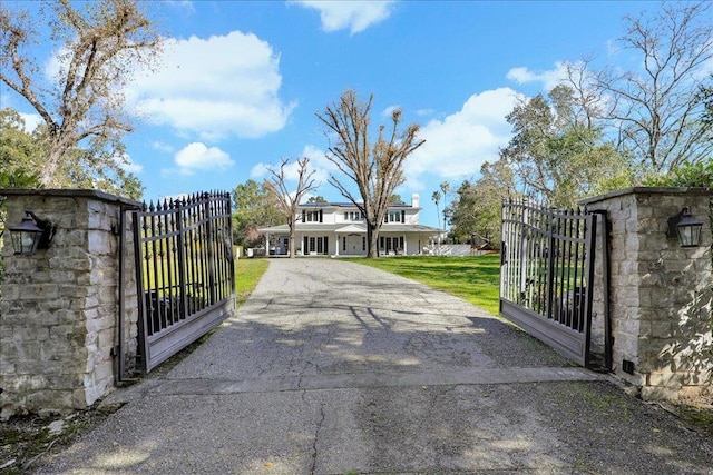 view of gate with a yard