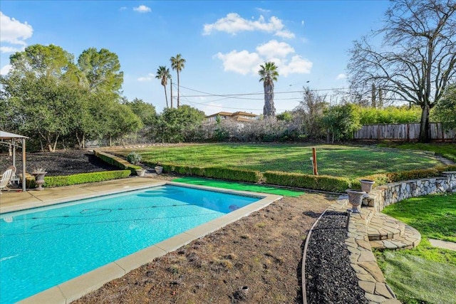 view of pool featuring a yard