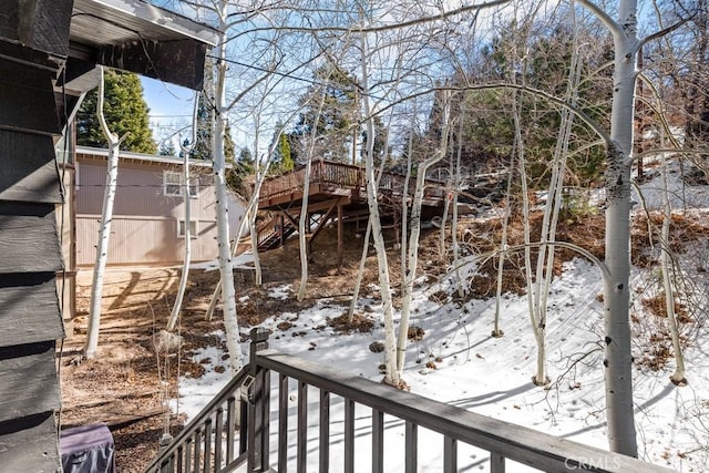 snowy yard featuring a wooden deck